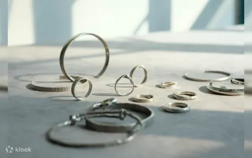 Expert tutor guiding a student through silversmithing techniques in Central