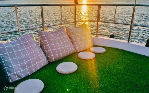 Passengers relaxing on the second-floor floating lawn area of the yacht