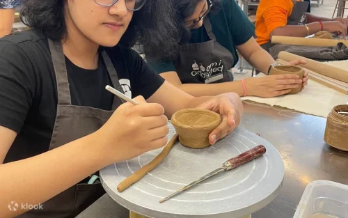 Friends and family enjoying a creative pottery class in Singapore