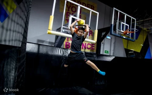Athletes conquering the challenging X-Park Ninja Warrior adventure course.