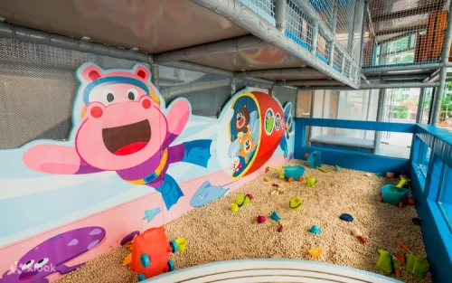 Children sliding into the mega ball pit at Kiztopia Club Singapore