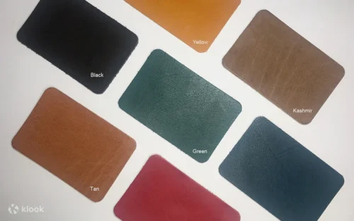 Participant hot-stamping initials onto a vegetable-tanned leather wallet