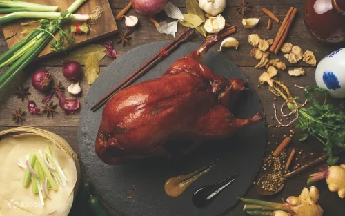 Skilled chef carefully slicing authentic Peking duck at the live cooking station