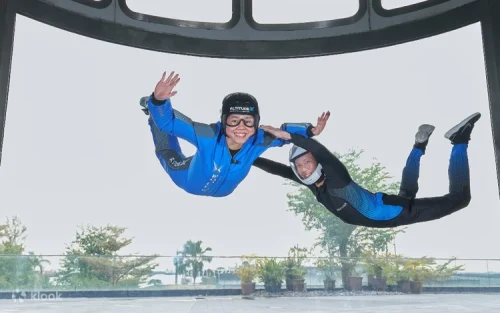 Certified instructor guiding a participant inside the state-of-the-art wind tunnel