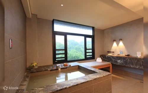 Lush green wall and minimalist lobby decor at the hot spring resort