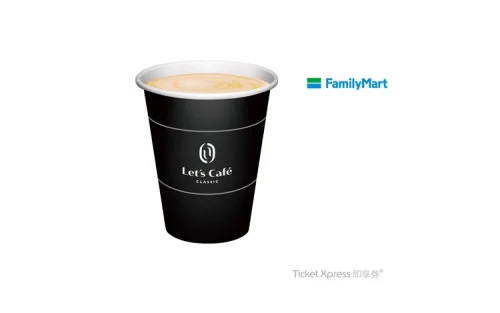 Close up of a warm cup of coffee against a bustling city street