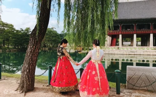 Woman wearing beautiful traditional Korean clothing walking through Bukchon Hanok Village