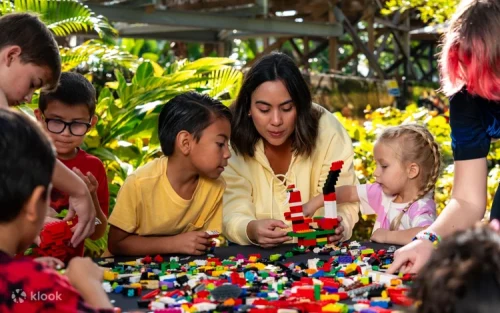 A family exploring the immersive LEGO Ninjago World themed area.