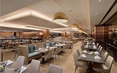 Expert chefs preparing hot dishes at live cooking stations