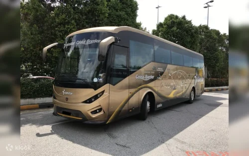 Passengers boarding the modern coach for the journey to Malaysia