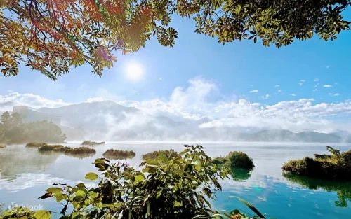Tranquil emerald waters of Sun Moon Lake surrounded by lush mountains