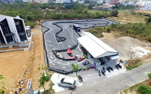 Single-seater go-kart speeding around a sharp hairpin turn