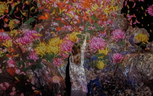 Children interacting with colorful digital projections at the Sketch Aquarium