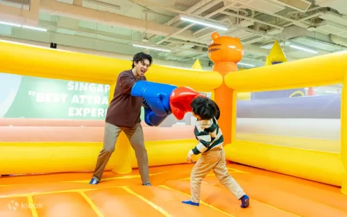 Happy family celebrating a birthday in the Bouncetopia party room