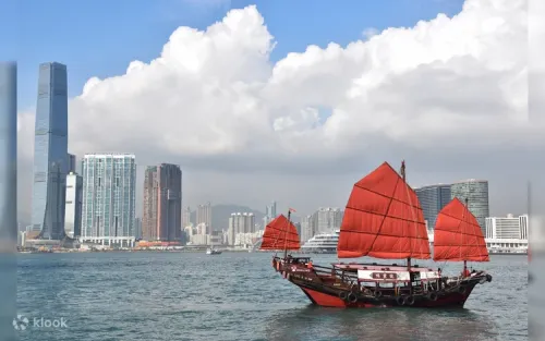 Passengers relaxing on the wooden deck of a historic Chinese junk boat during a sunny daytime sail.