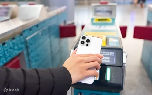 Travelers scanning QR codes for quick entry at the station gates