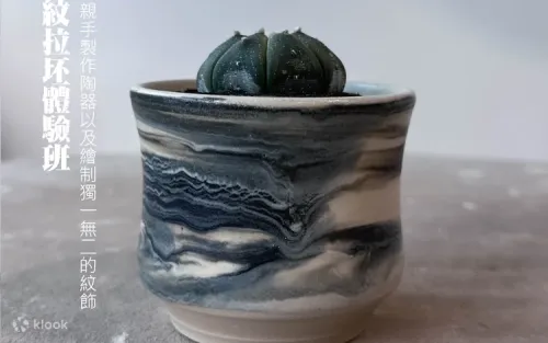 Instructor guiding a student in shaping a ceramic bowl