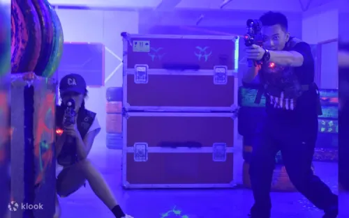 Players wearing high-tech sensor vests in a sci-fi laser tag maze