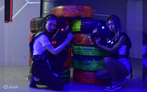 Children and adults aiming laser blasters during a painless shootout game