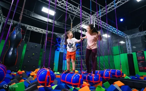 Challenger navigating the thrilling indoor ninja obstacle course