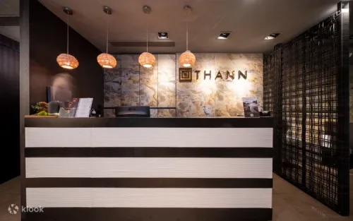 Warm gray interior and soft lighting at the THANN Sanctuary reception