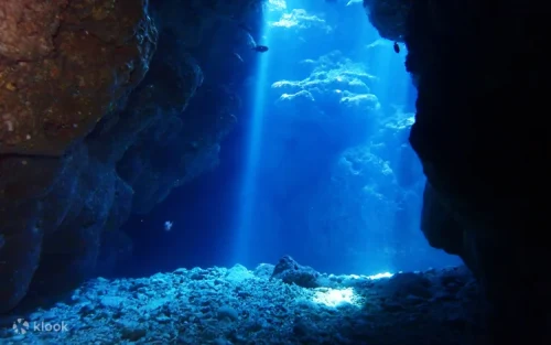 Ethereal glowing blue waters inside the famous Onna Village cave