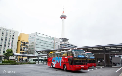 Passengers enjoying panoramic views of Nijo Castle from the open-top bus