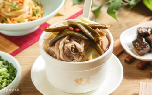 Steaming bowl of nourishing clam and chicken soup for holistic health