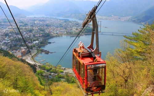 Travelers riding the Kawaguchiko Ropeway up Mount Tenjo on a clear sunny day
