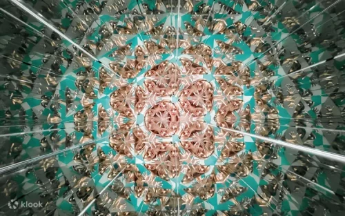 Friends taking creative photos in the kaleidoscope mirror exhibit
