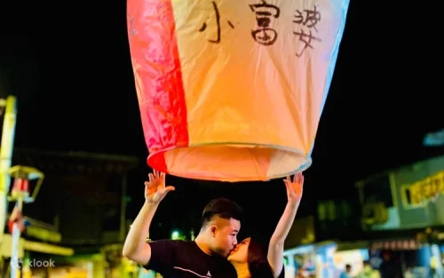 Writing wishes on a colorful paper lantern at Shifen Old Street