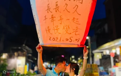 Hundreds of illuminated sky lanterns floating into the night sky