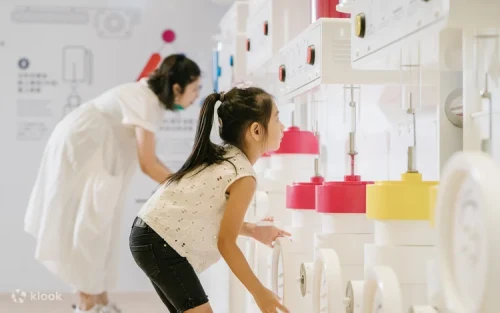 Children drawing on the interactive graffiti wall in Taoyuan