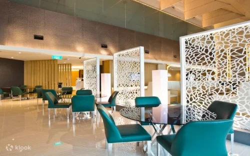 Comfortable sofa seating area with panoramic runway views at Changi Airport