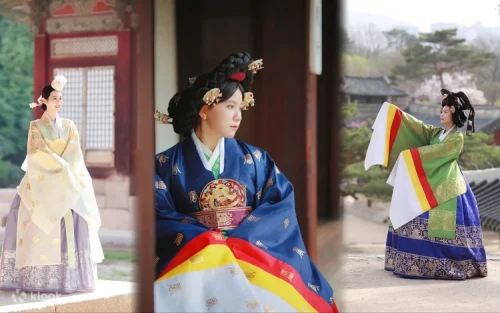 Couple dressed in vibrant traditional Korean garments walking through the historic gates of Changdeokgung Palace