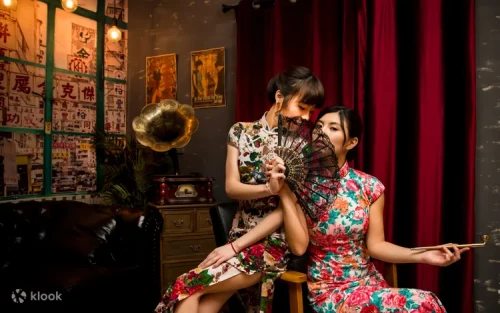 Couple walking through Old Town Central in traditional Cheongsam outfits