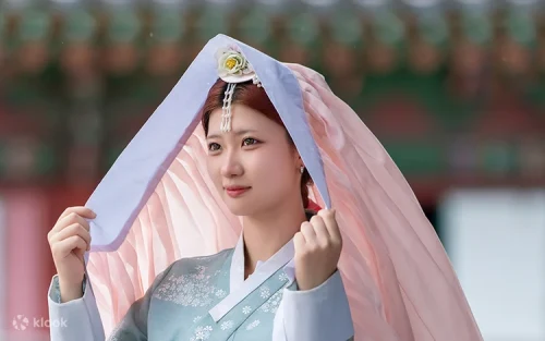 Professional K-Beauty makeup artist applying cosmetics to a guest