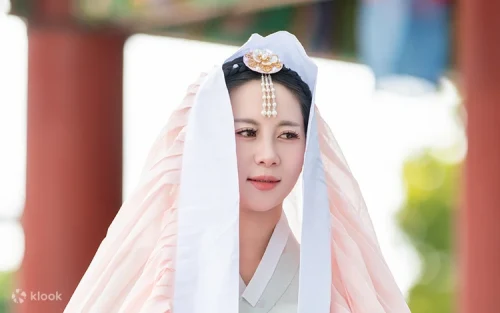 Couple wearing Korean school uniforms posing at Jejumok-Gwana