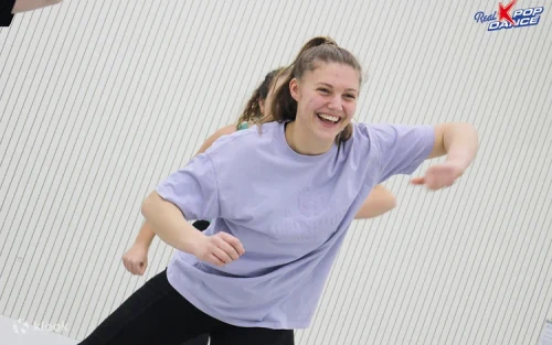 Energetic dance practice session with vibrant studio lighting