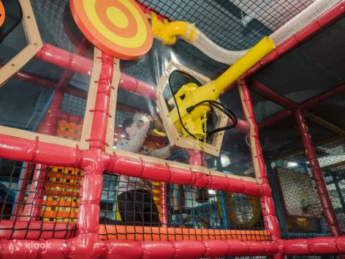 Children sliding down the colorful wave slides at the indoor play arena