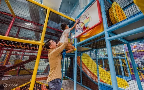 Kids playing in the massive ball pit splash and interactive obstacle course