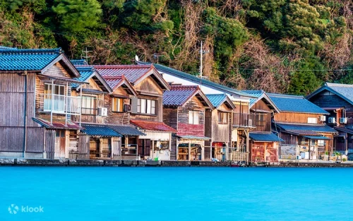 Traditional wooden Ine Funaya boathouses floating on the serene waters of Japan