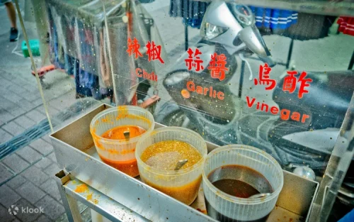 Close-up of thin chewy flour-rice noodles in rich fragrant broth