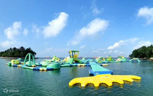 Friends leaping off the floating jump tower into the refreshing sea at Sentosa