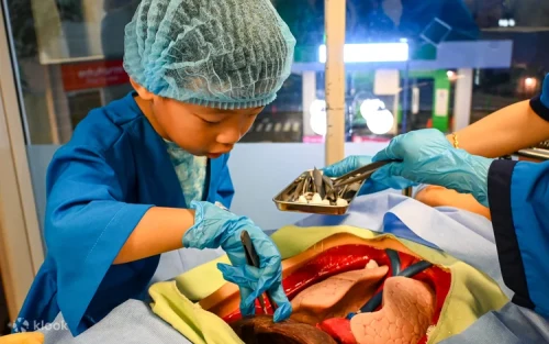 Young aspiring surgeons performing a mock operation in the hospital