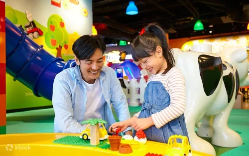 Children building creative structures at the interactive LEGO workshop
