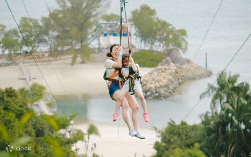 Brave adventurers navigating the thrilling MegaClimb ropes course in Singapore.
