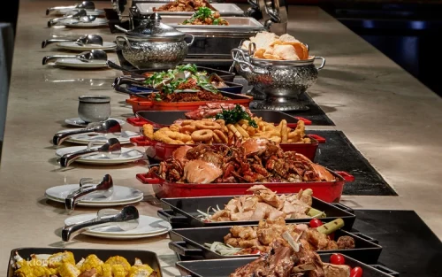 Expert chef carving high-quality roasted meats at live station