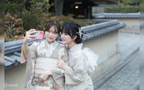 Elegant woman wearing a premium furisode kimono posing gracefully near Kiyomizu-dera Temple.