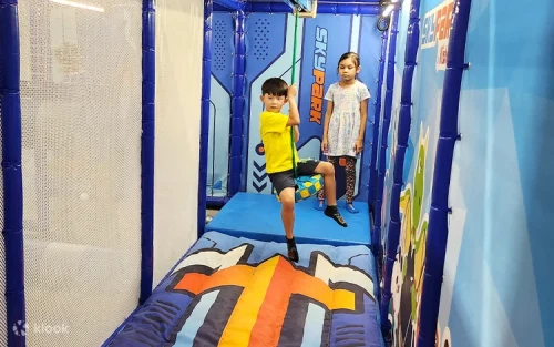 Families enjoying sporty indoor playground activities together